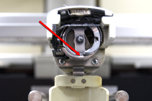 Place one drop of clear sewing machine oil at the point where the rotating hook rests.